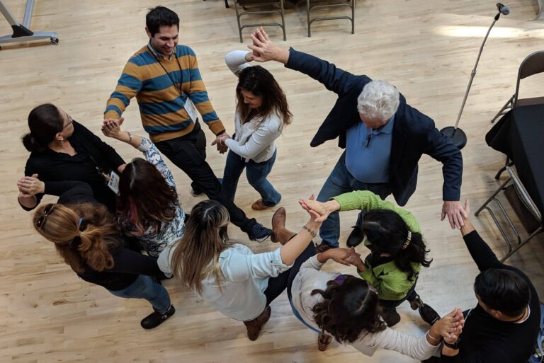 A group exercise involving a tangle of hands and feet